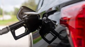 Refueling a black SUV at a gas station in close view