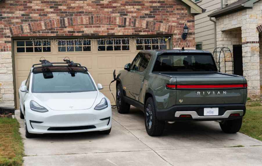 A Tesla Model S and a Rivian R1T parked in a driveway