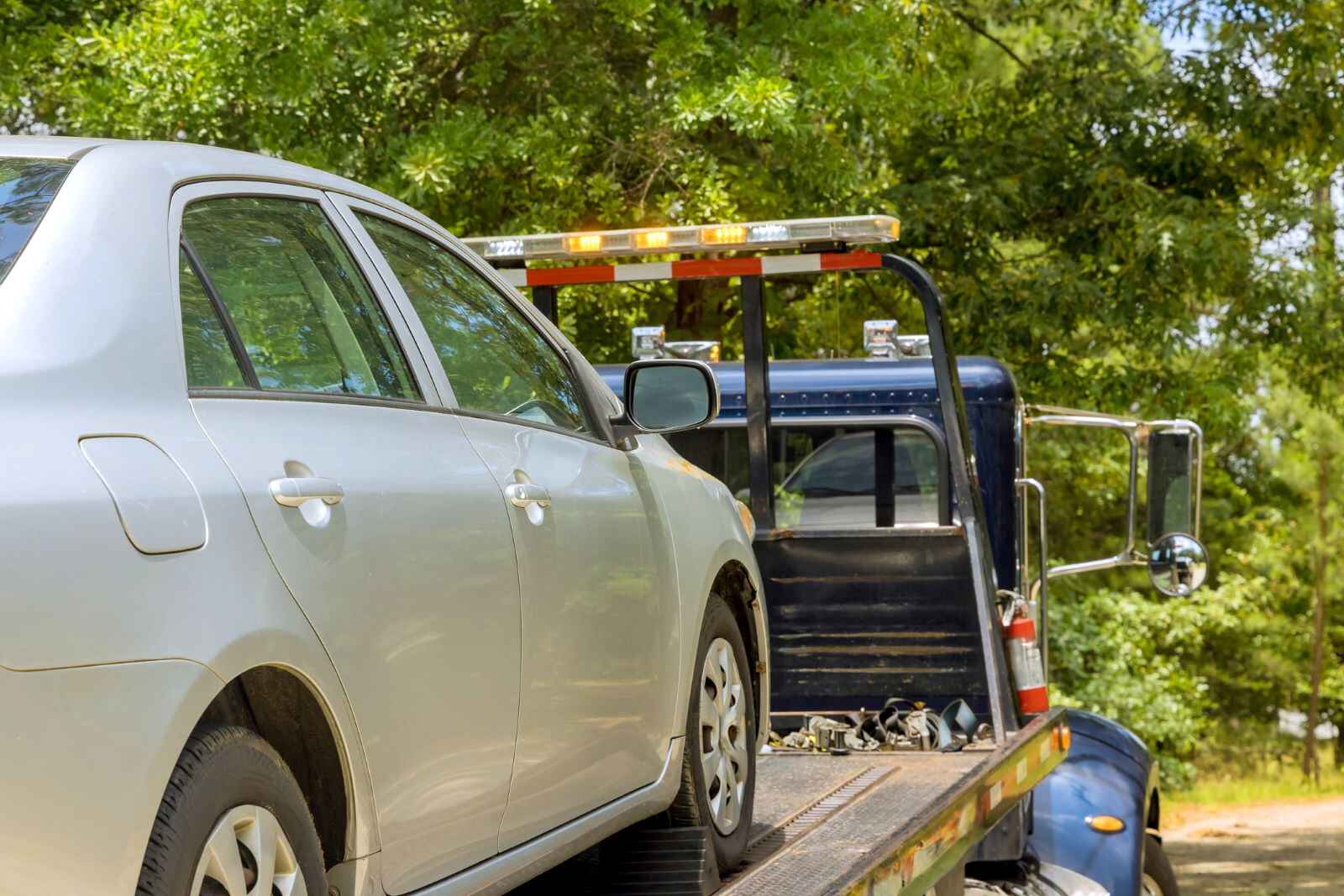 A car on the back of a tow truck