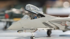 A grey painted toy jet in close left front view