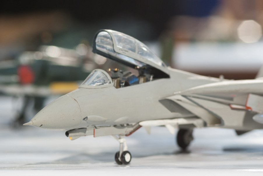 A grey painted toy jet in close left front view