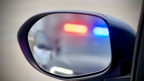 The view of a traffic stop taking place from driver's side mirror view