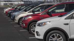 Used car inventory at a Ford dealership in close left fender view