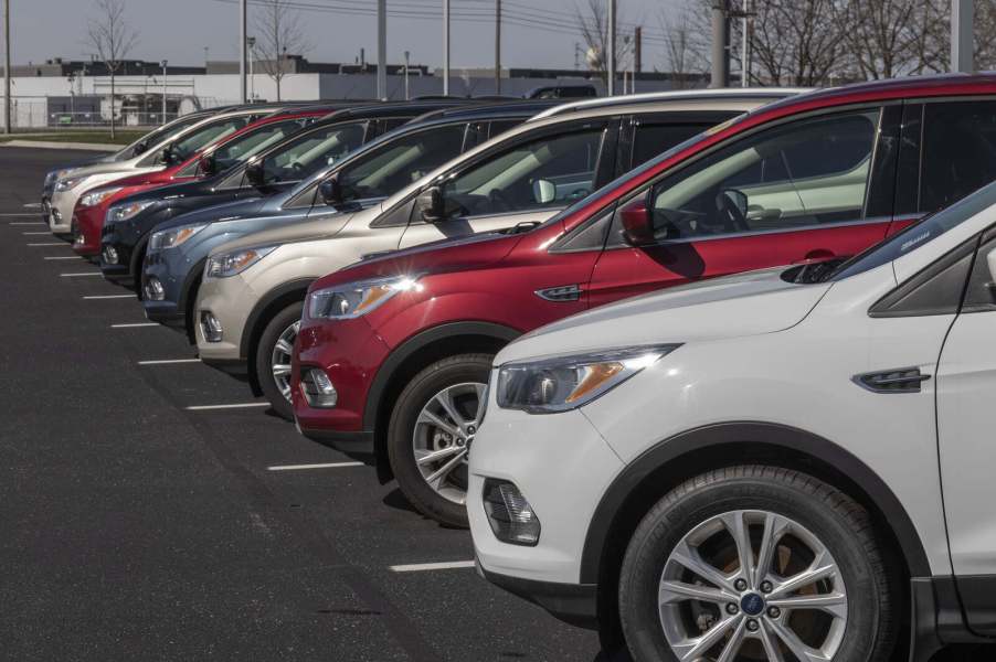 Used car inventory at a Ford dealership in close left fender view