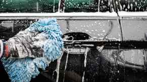 Soapy car wash by hand in close view