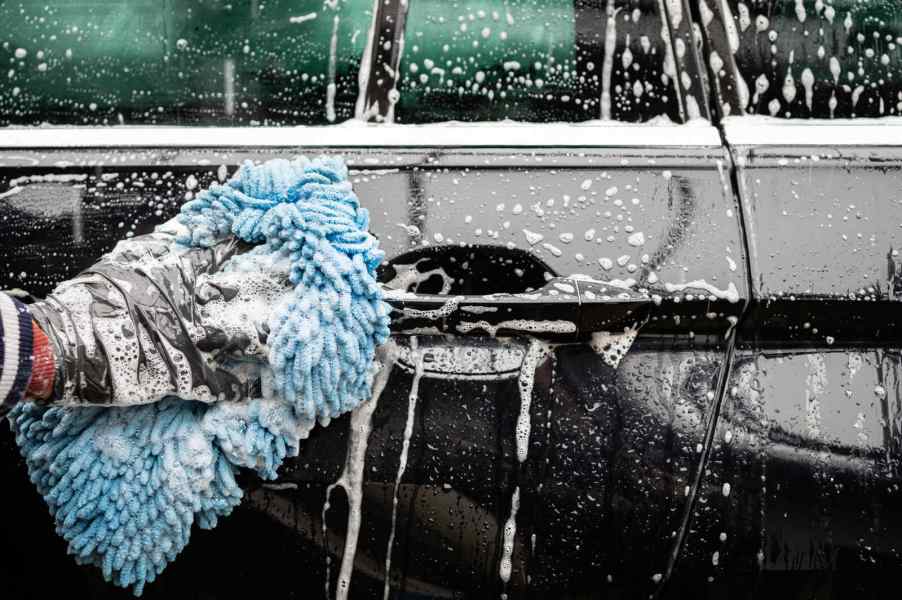 Soapy car wash by hand in close view