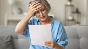 An elderly woman shocked after opening a bill