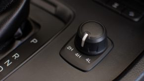 A 4WD to 2WD setting knob in a car's interior in close view