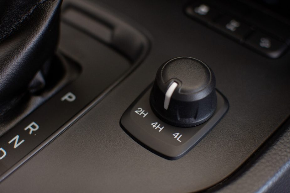 A 4WD to 2WD setting knob in a car's interior in close view