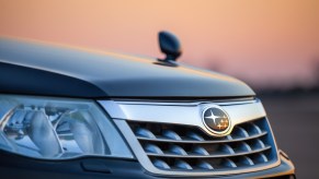 Subaru grill closeup, with the sun visible in the background.