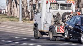 Tow truck driver responding to an accident scene during a scam common in California