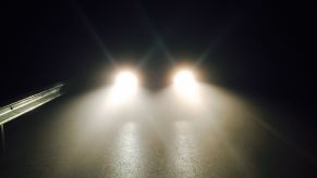 A car's headlights reflecting on the road at night