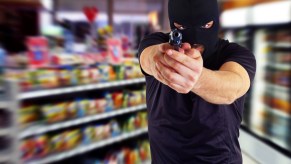 A robber with a gun inside a store