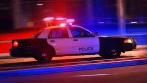 A police car speeding down a street responding to an emergency