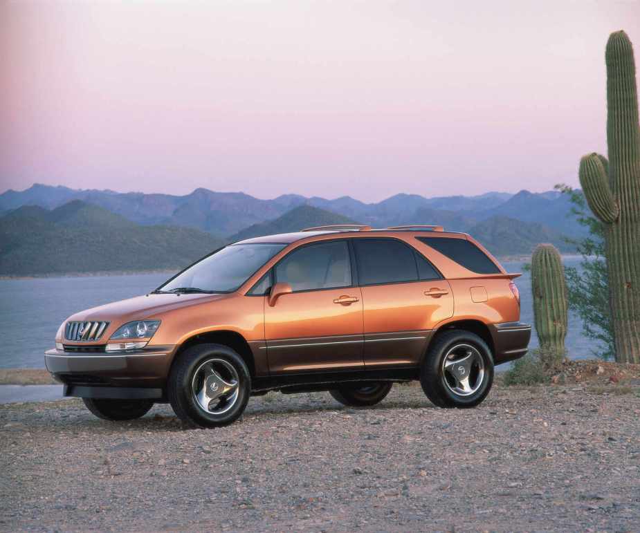 A burnt-orange colored 1998 Lexus RX 300 parked on desert gravel in left front profile view at sunset