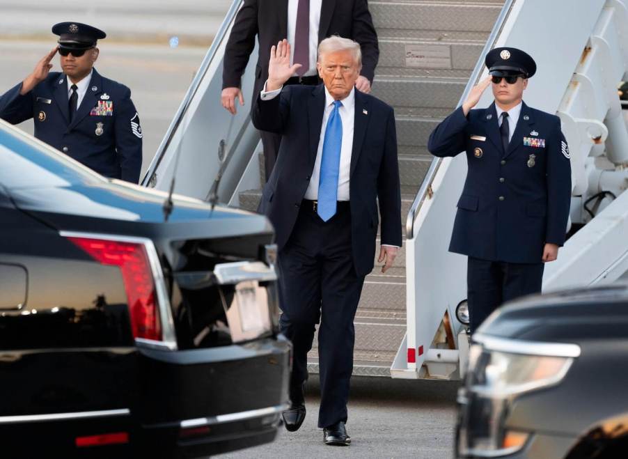 Donald Trump exits Air Force One. Trump says he doesn't care if rising car costs impact American consumers.