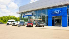 Cars lined up outside a Ford dealership.