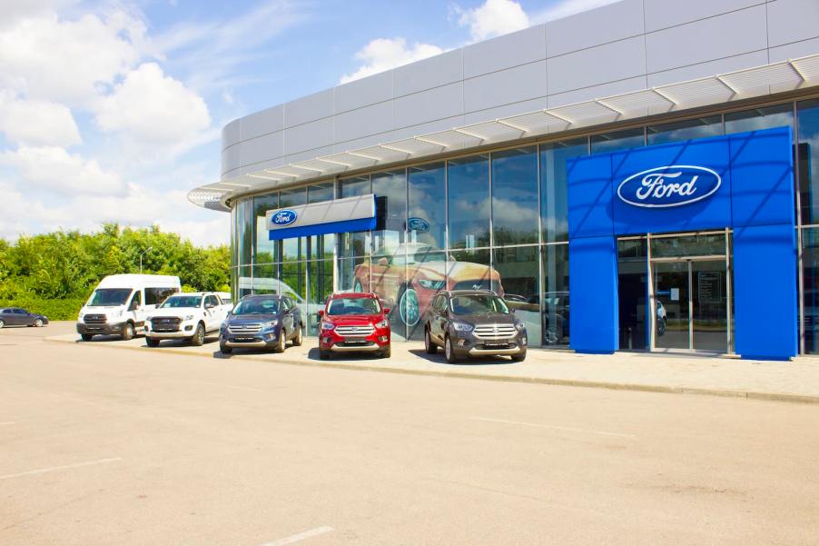 Cars lined up outside a Ford dealership.