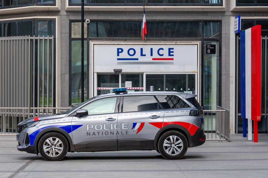 A French police vehicle parked near a police station after a car chase.