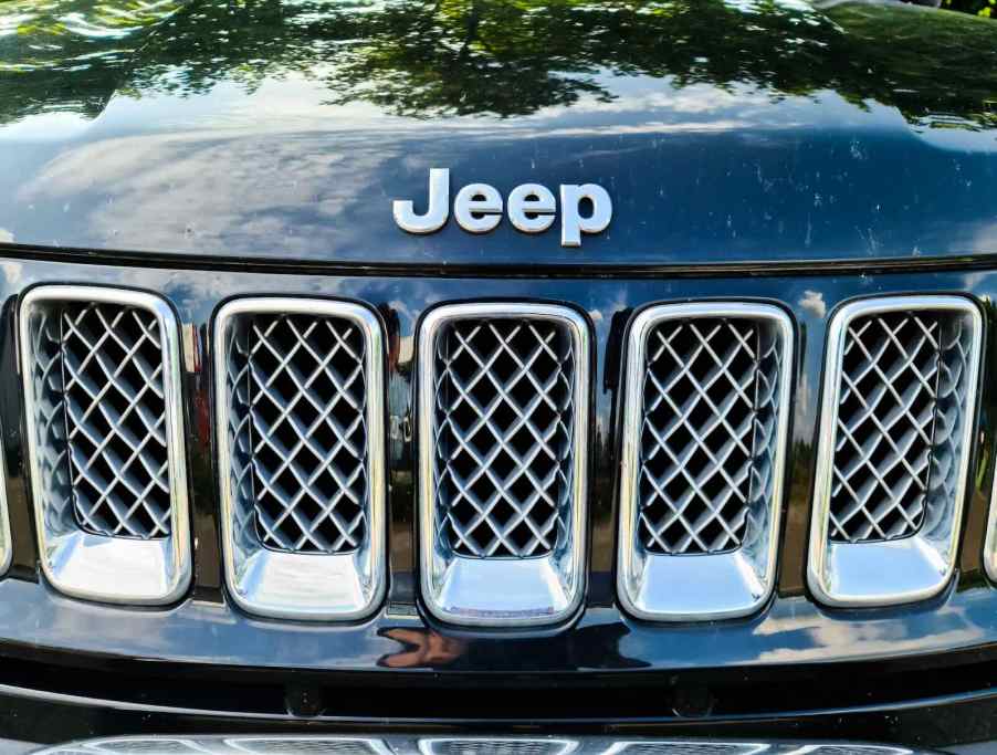 Black Jeep badge on an SUV's grille.