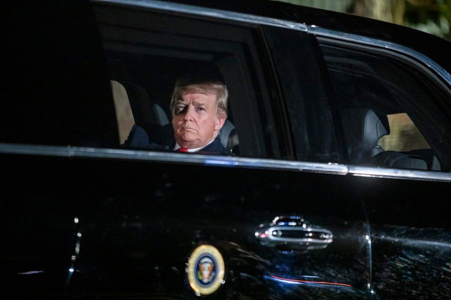 President Donald Trump looks out the window of his Cadillac Limousine, "The Beast"