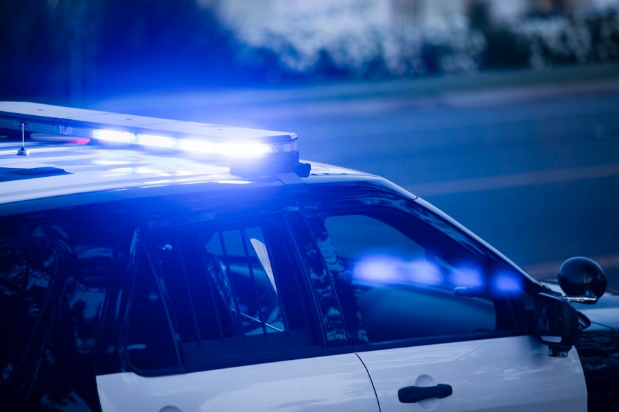 Flashing blue lights on top of a police interceptor during a Maine chase