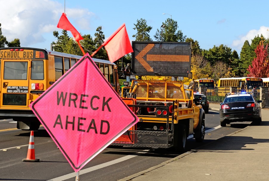 A sign arming about a School bus wreck