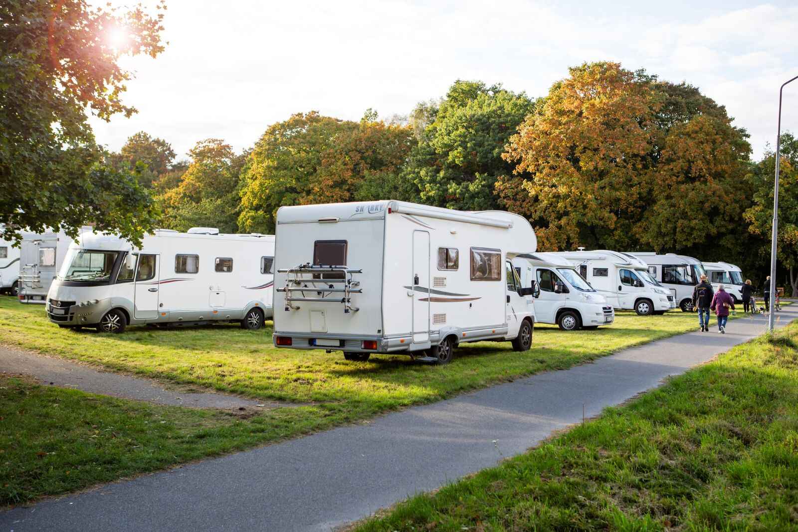A storage lot full of luxury RVs
