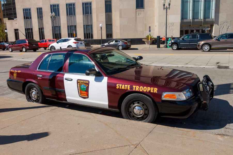 A Minnesota State Trooper cruiser parked at a curb