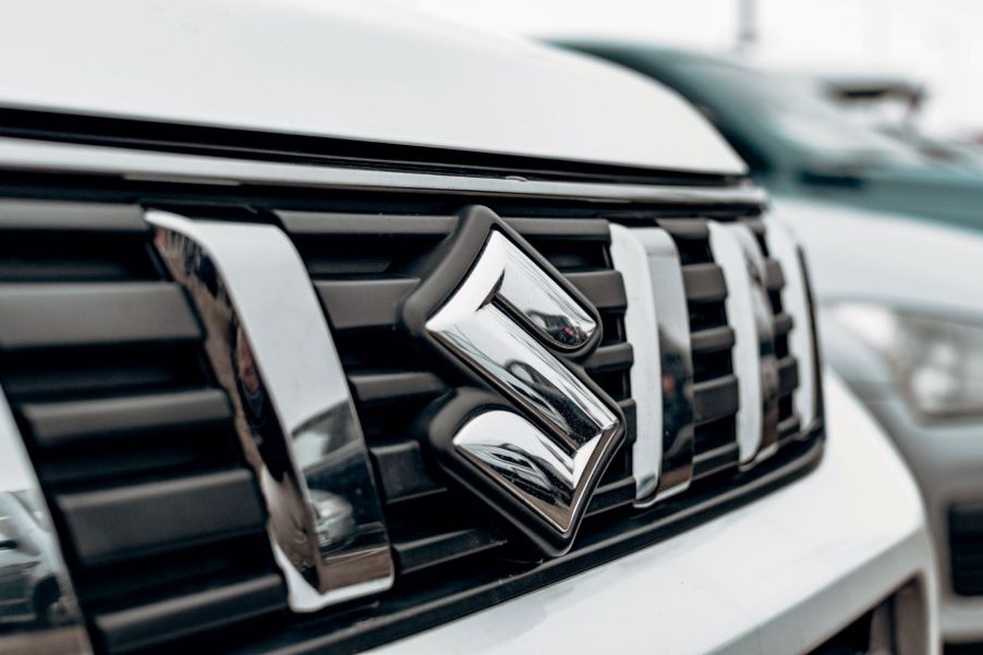 A Suzuki badge on a car's grille