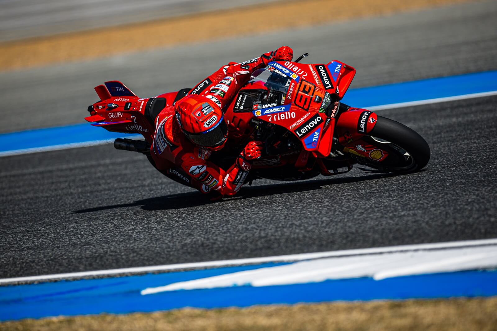 A Ducati Lenovo MotoGP racing motorcycle in a corner.
