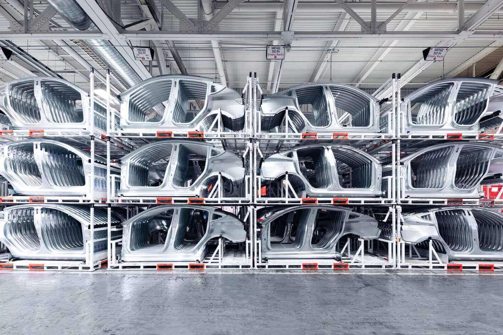 A row of stacked Tesla vehicle components at Fremont.