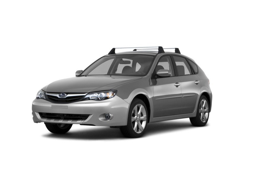 A 2011 Subaru Outback wagon on a white background in left front angle view