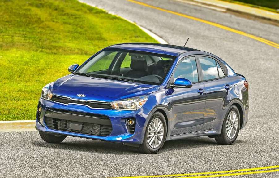 A blue 2018 Kia Rio driving in left angle view