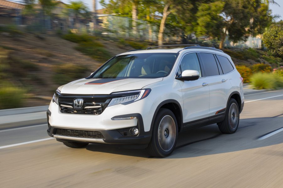 A white 2019 Honda Pilot SUV driving on a road