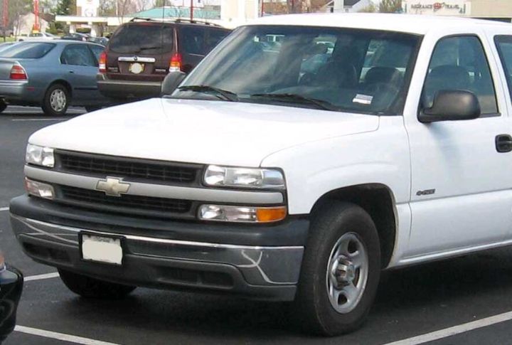 A white Chevrolet Silverado 1500 in a parking lot