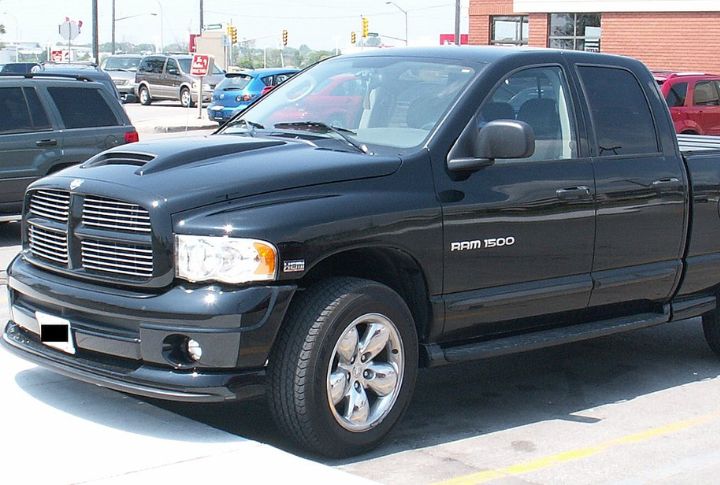 A black Dodge Ram 1500 parked in left front angle view.