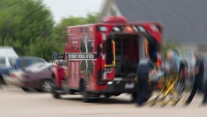 Red ambulance responds to parking lot to save Florida woman dragged by SUV