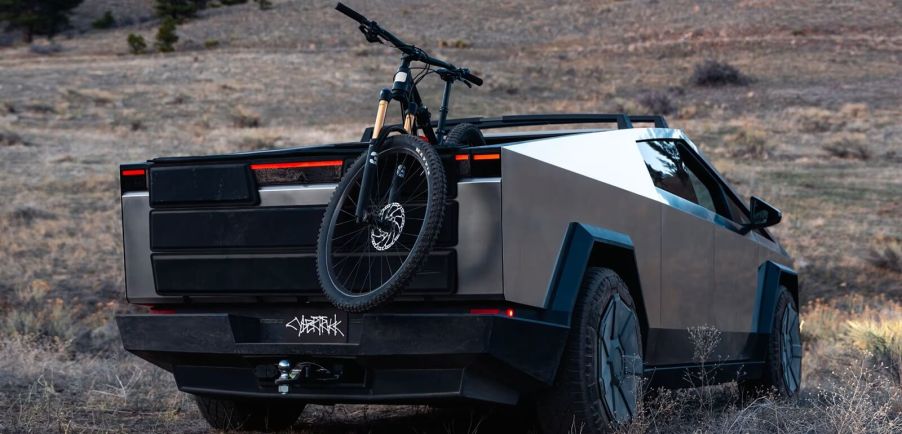 A Tesla Cybertruck with a mountain bike, showing the rebrand of the EV.