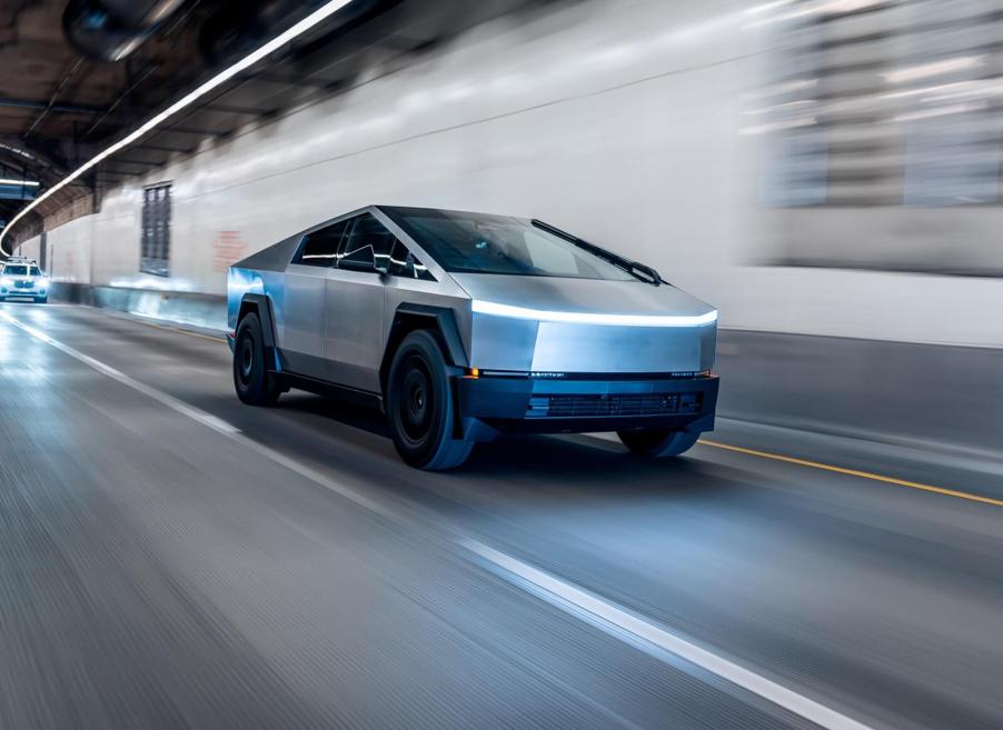 A Tesla Cybertruck, a common target for vandalism, rolling through a tunnel.