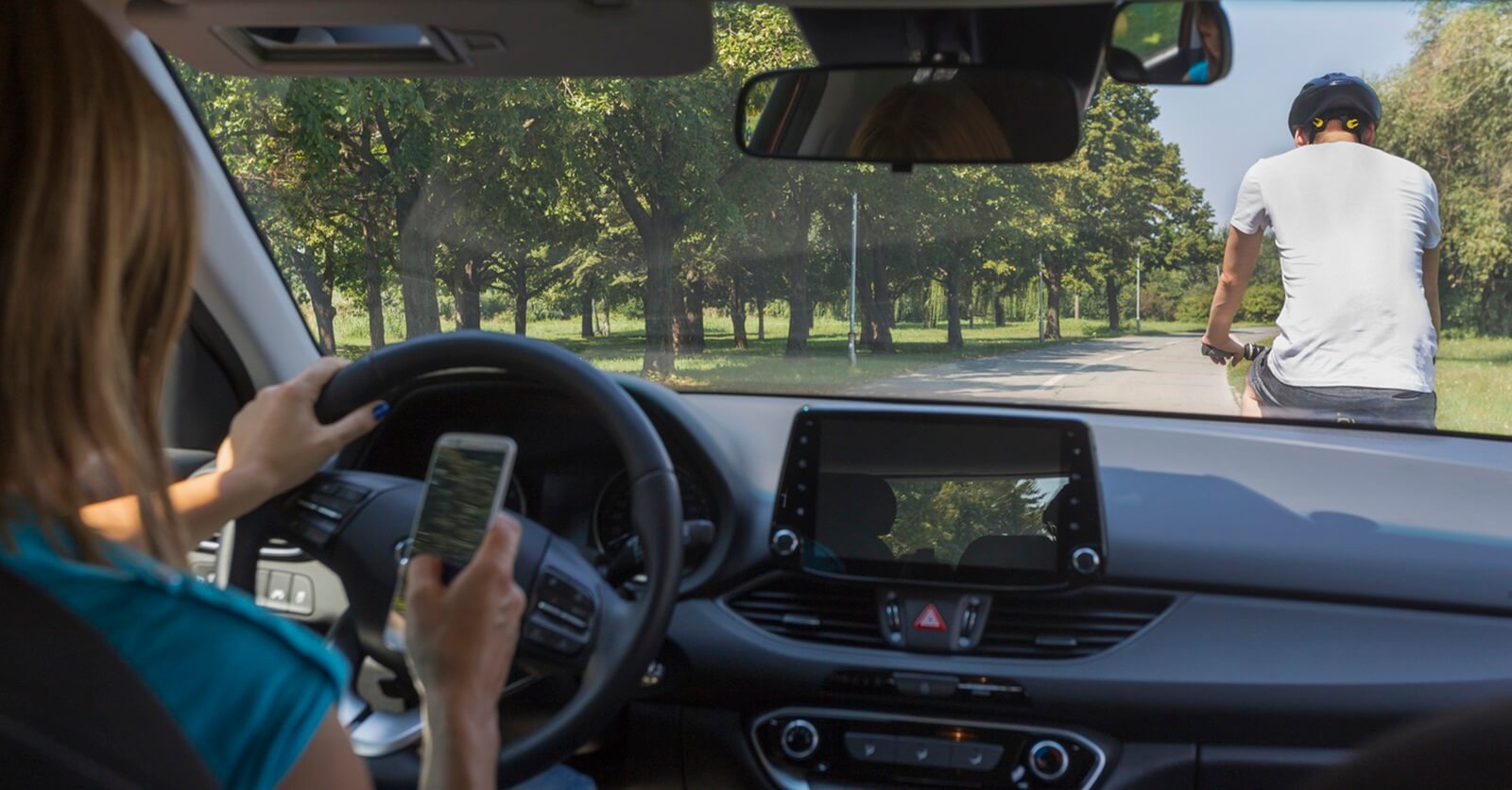 A woman nearly hits a Florida man on a bicycle while distracted driving.