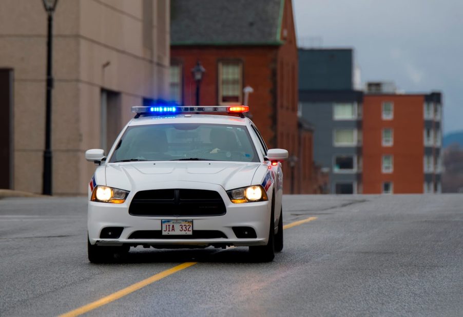 A Dodge Charger police unit in a high-speed chase on city streets.