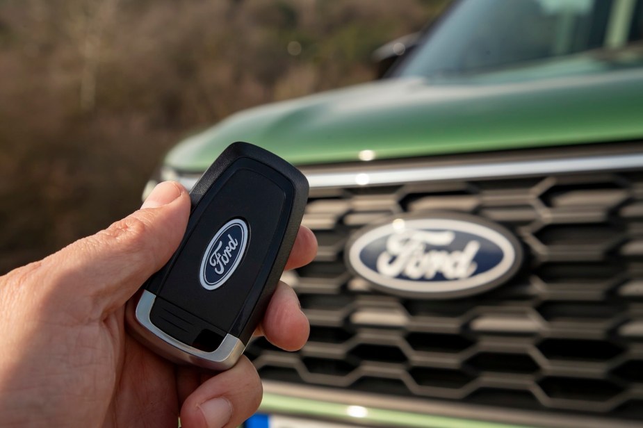 Ford logo on the key fob and grille of a new vehicle