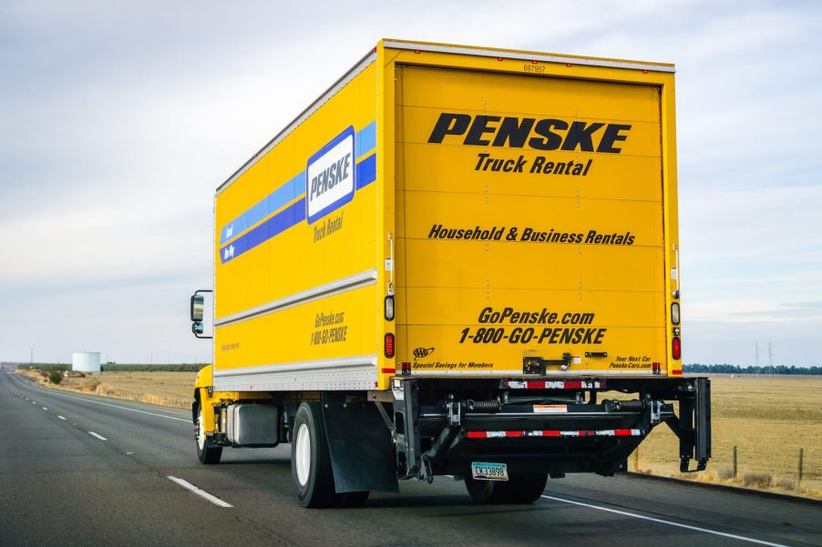 Bright yellow Penske rental truck on the highway, fleeing from police