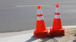 Stack of traffic cones in Norfolk Virginia, the pavement of the street visible in the background.