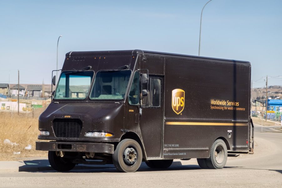 UPS delivery trucker driver in his brown van.