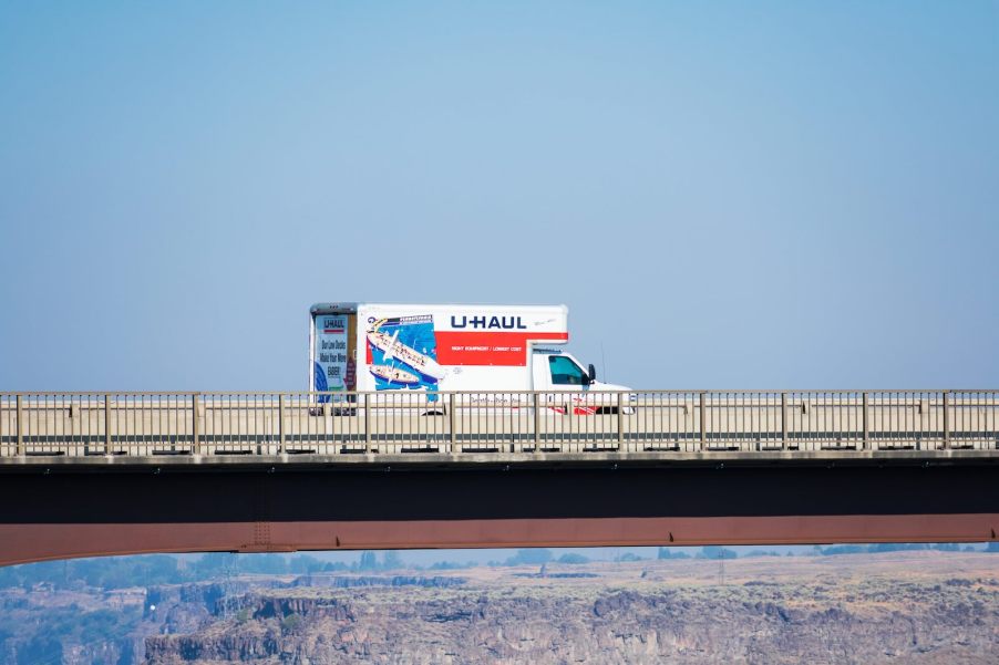 White and red Uhaul truck on bridge over cliffs in Santa Fe, New Mexico