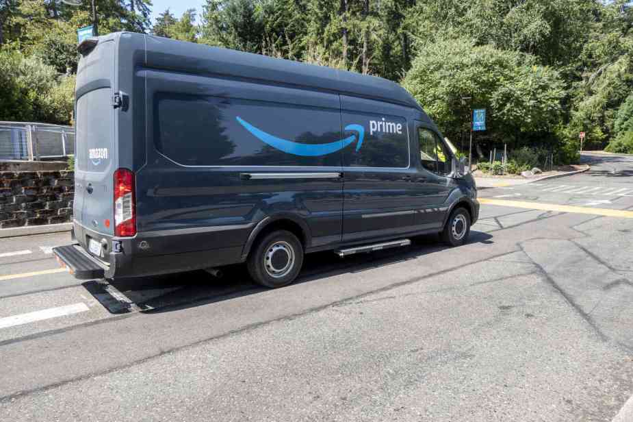 An Amazon delivery van driving on a road