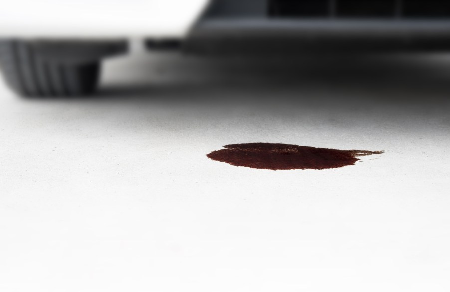 Car leaking oil in close view of ground