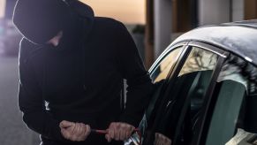 A person trying to break into a car